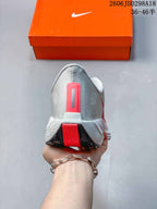 Rear view of the sneaker showing the grey heel, red vertical accent, white midsole, and black outsole.