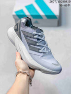 Angled side view of the gray adidas shoe showing the layered upper, heel structure and visible LIGHTSTRIKE PRO text on the midsole.