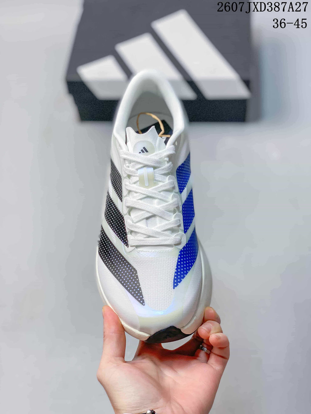 Top view of the white lace-up sneaker showing blue and black patterned side stripes.