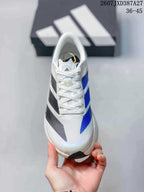 Top view of the white lace-up sneaker showing blue and black patterned side stripes.