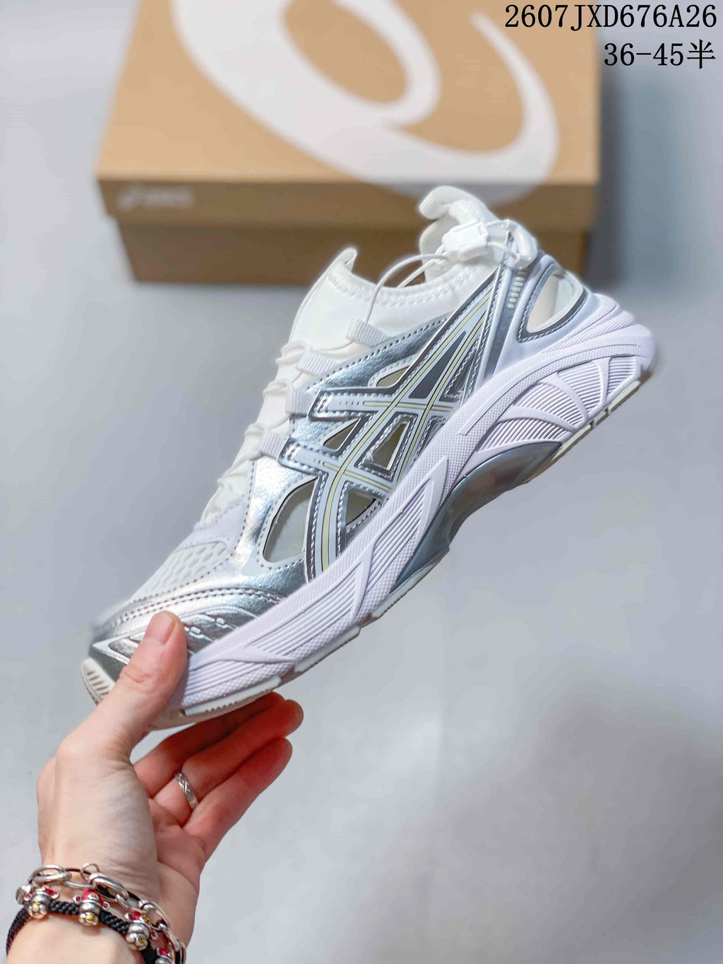 Side profile of the white and silver sneaker showing the layered upper, ASICS branding, mesh panels, and sculpted midsole.