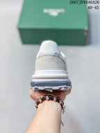 Rear view of the sneaker showing the padded heel, layered midsole, and gray outsole section.