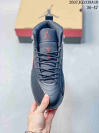 Front view of the sneaker showing the padded tongue, red Jumpman-style logo, laces, and rounded toe.