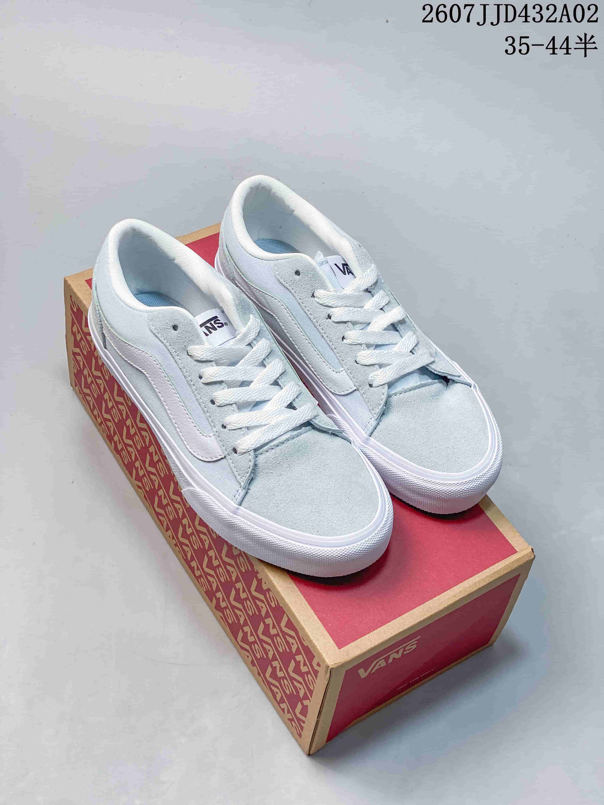 Pale blue and white Vans low-top sneakers with lace-up fronts.