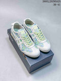 Pair of white Onitsuka Tiger sneakers with green and blue floral panels displayed on a shoe box.