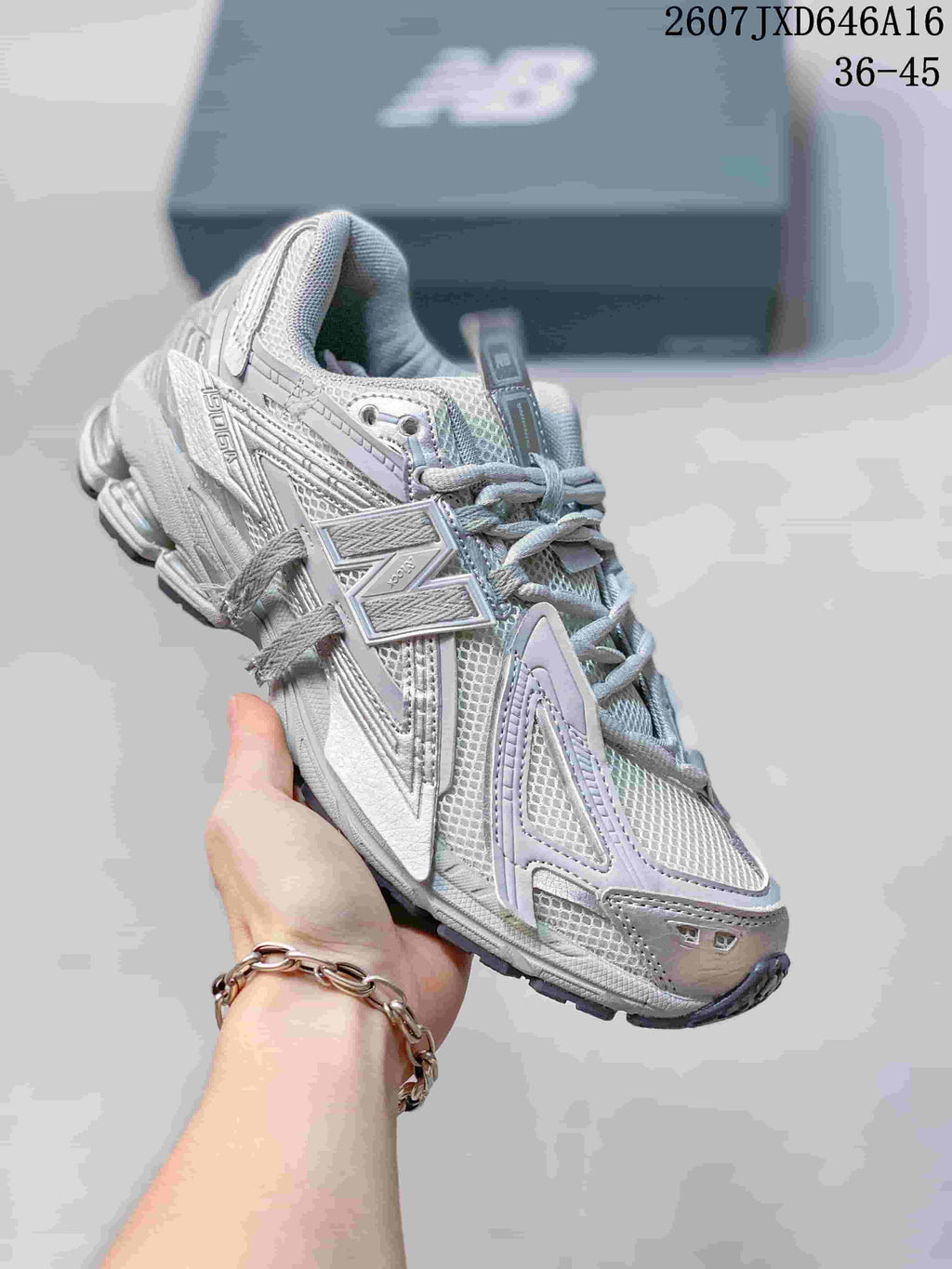Angled side view of the New Balance 1906A sneaker showing the large side logo and layered upper.