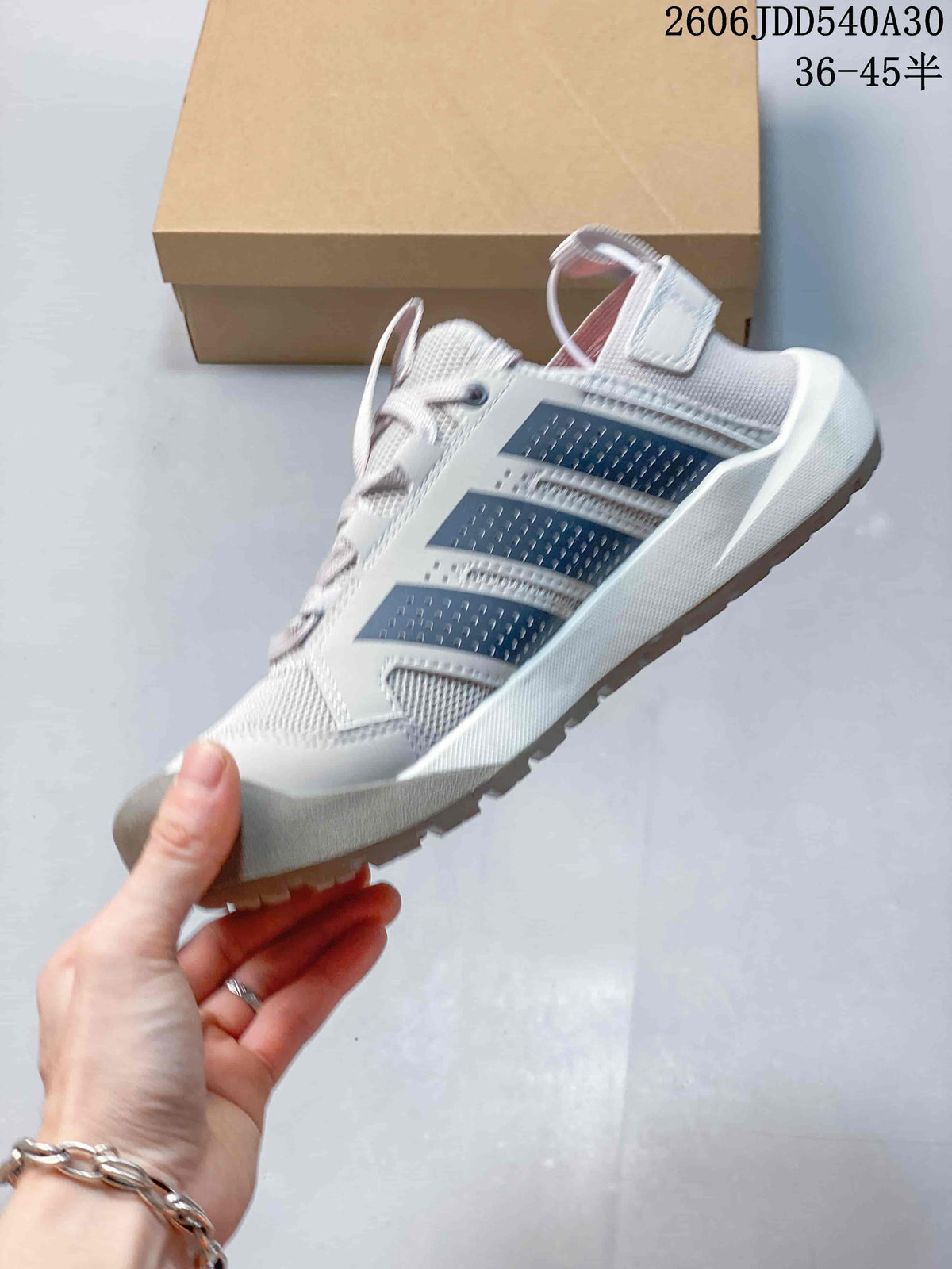 Side view showing the dark stripes and upper of the Adidas Terrex Daroga 25