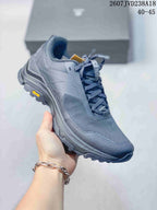 Angled side view of the Kailas hiking shoe showing the toe guard, layered upper, Vibram outsole marking, and deep lugs.