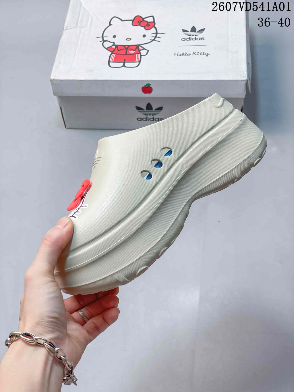 Side view of a cream mule clog showing ventilation holes and a raised sole
