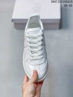 Top view of the white sneaker showing the laces and stitched toe design