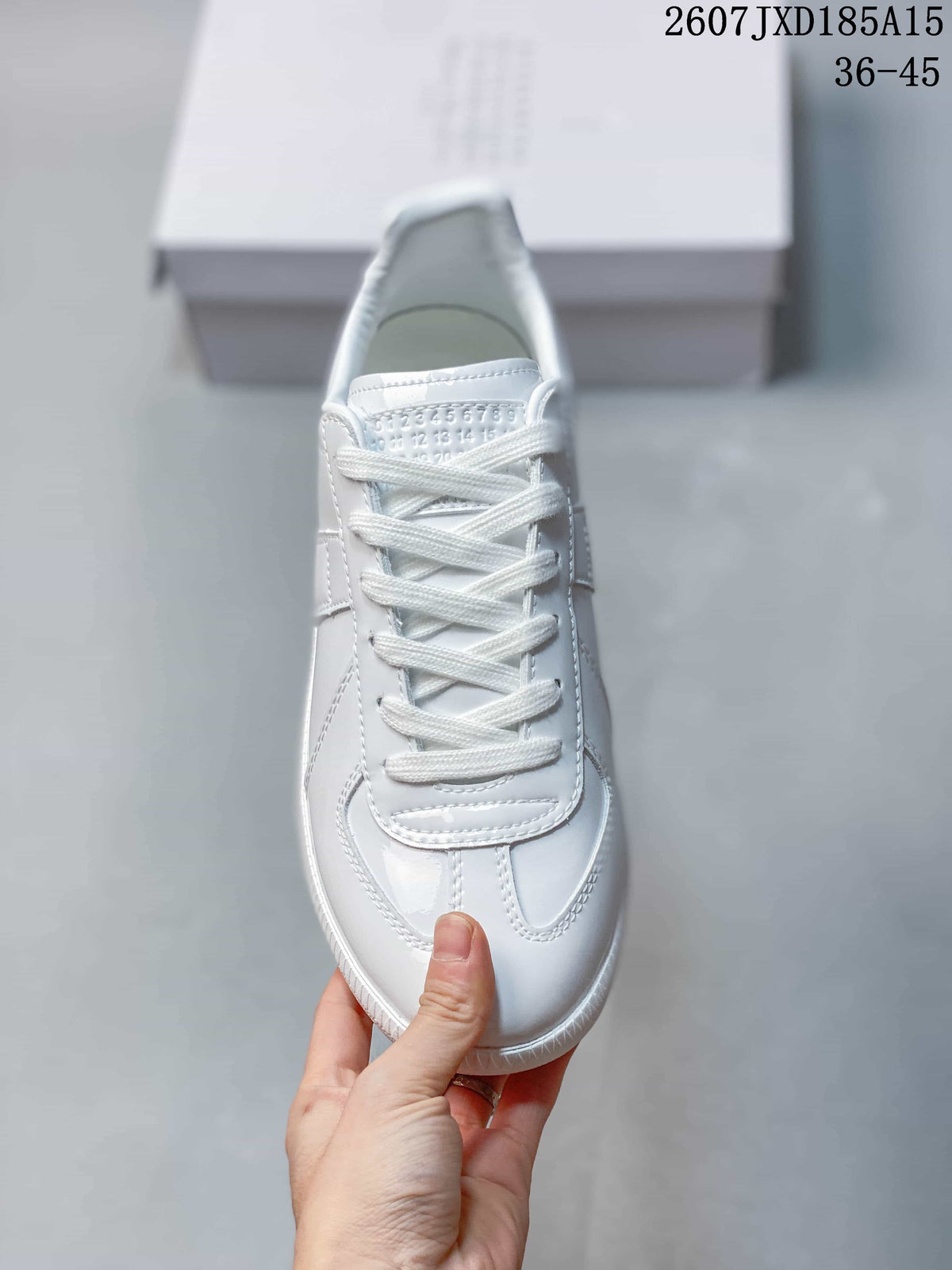 Top view of the white sneaker showing the laces and stitched toe design