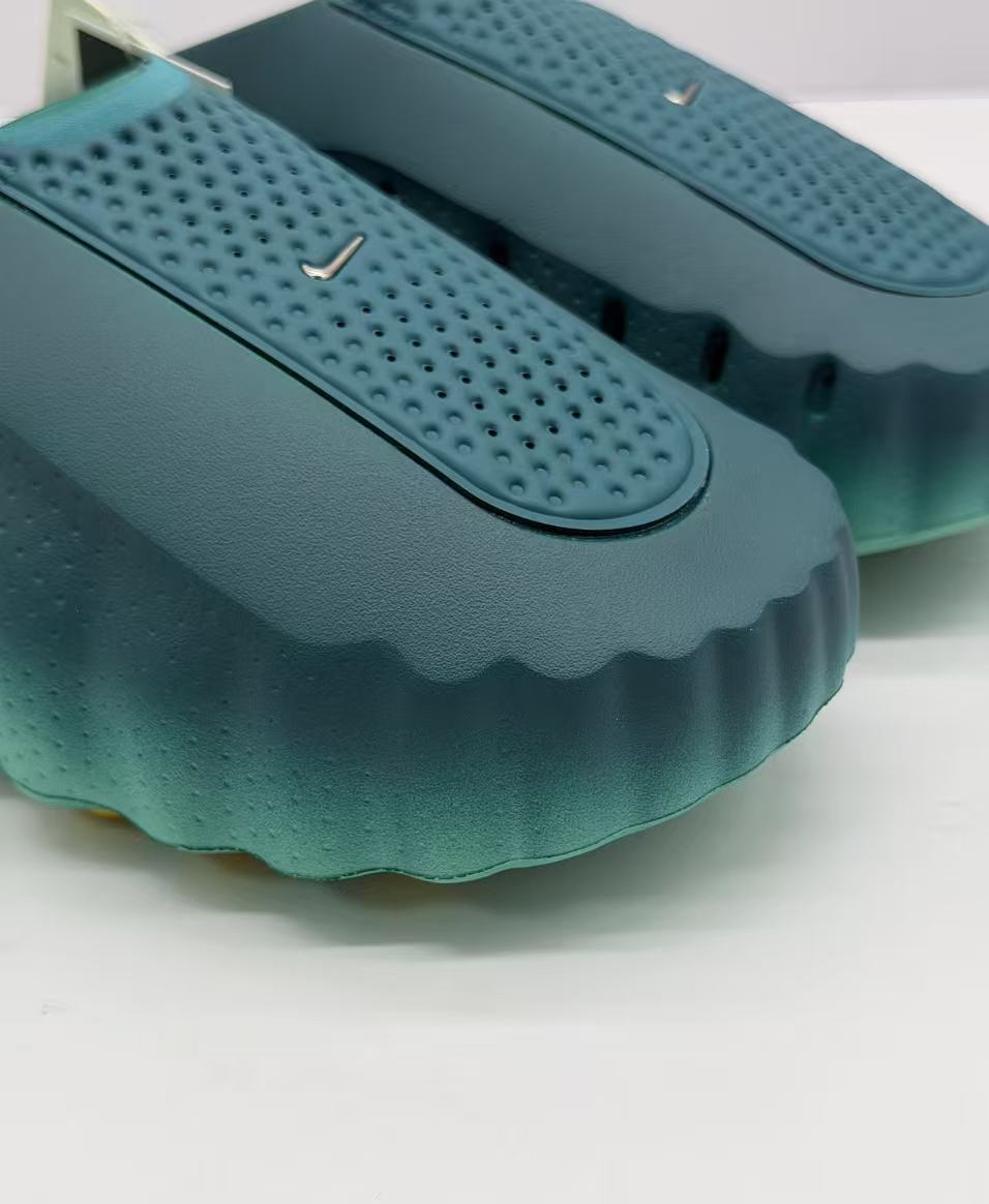 Close-up of the perforated upper panel and small metallic Nike swoosh detail.