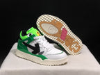 Angled view of the sneakers with one shoe lifted to show the patterned cream outsole and colored tread sections.