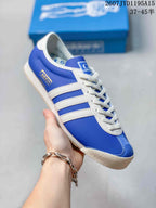 Close side view of a blue and white sneaker showing the three stripes and textured outsole.