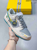 Close view of a low-top sneaker with gray panels and teal and yellow accents