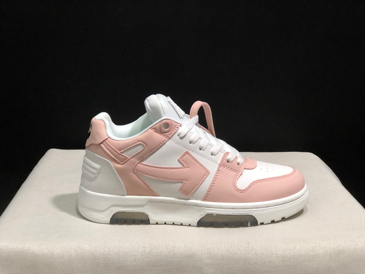 Single side profile of the white and pale pink sneaker against a dark background.