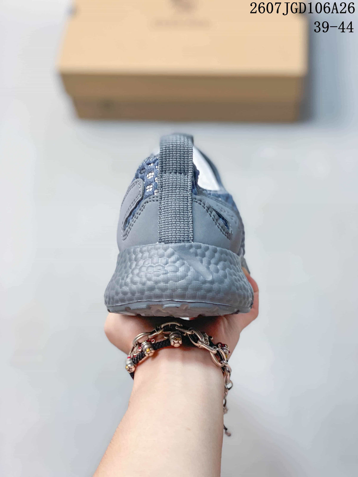 Rear view of a blue-gray sneaker showing the heel pull tab, padded heel area, and textured sole.