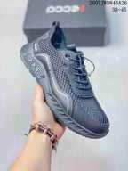Angled side view of a dark gray ECCO sneaker showing the mesh upper, lace detail, overlay panels and textured sole.