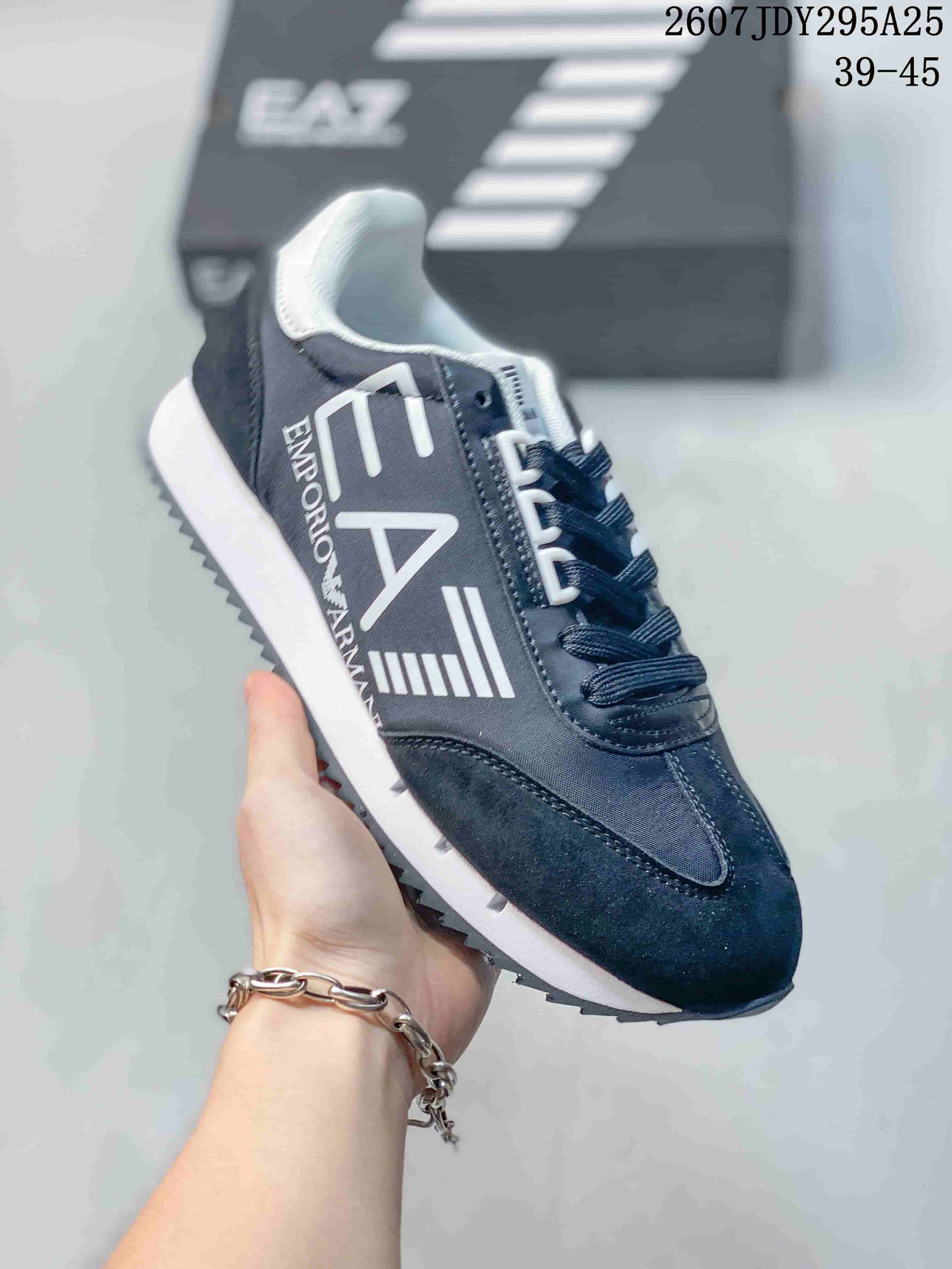 Side view of the navy sneaker showing the large EA7 side graphic, Emporio Armani text, white midsole, and dark outsole.