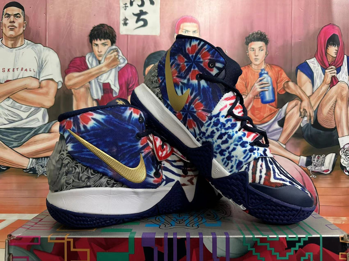 Pair of blue, white, and red high-top basketball shoes with gold side accents, shown from the side.