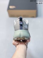 Rear view showing the padded heel, pull tab, pale green midsole and The North Face branding.