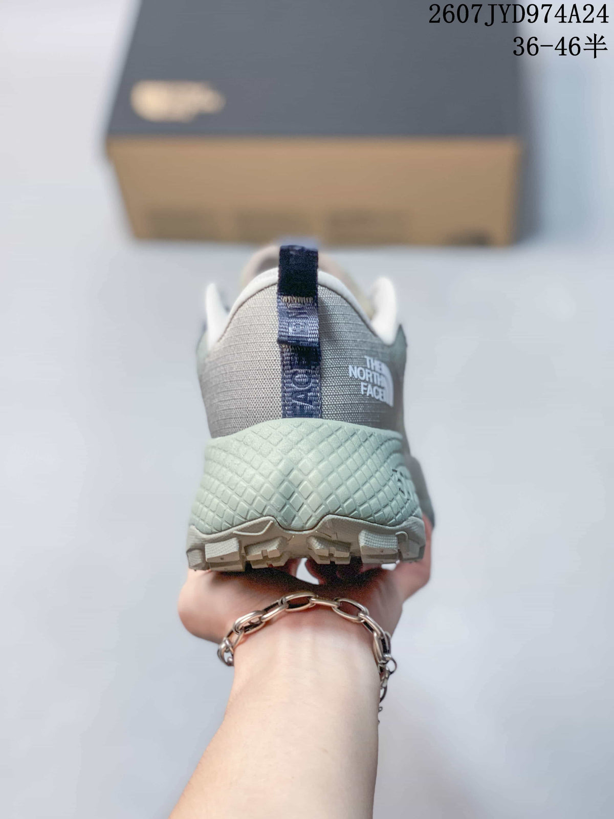 Rear view showing the padded heel, pull tab, pale green midsole and The North Face branding.