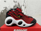 Side view of a red, black, and white Nike Flight sneaker with a gold-tone swoosh and sculpted midsole