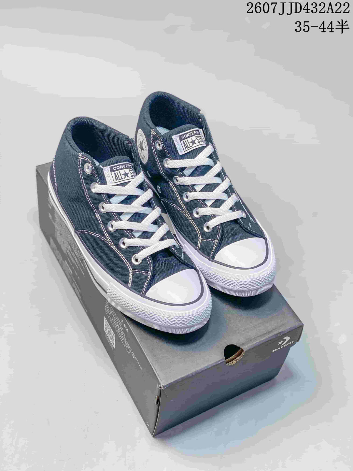 Pair of navy Converse Chuck Taylor All Star Malden Street high-top sneakers displayed on a shoe box.
