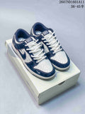 Pair of navy and white low-top sneakers displayed on a shoe box, with the style code and advertised size range visible at the top.