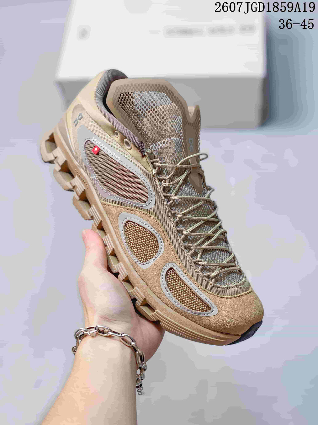 Angled side view of the beige On sneaker showing mesh panels, reflective-looking trim, laces, and the outsole design.