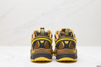 Rear view showing the layered heel structure, pull tabs, dark heel panels, and yellow outsole sections.