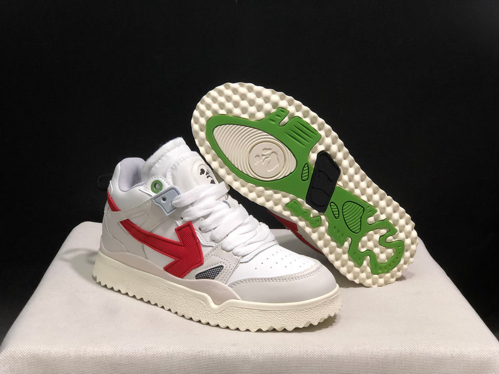 White sneaker shown beside its outsole, which features green and black traction sections with a textured cream edge.