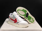 White sneaker shown beside its outsole, which features green and black traction sections with a textured cream edge.