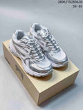 Silver and white Trispeed 3000 Trainer sneakers shown from above on a shoebox