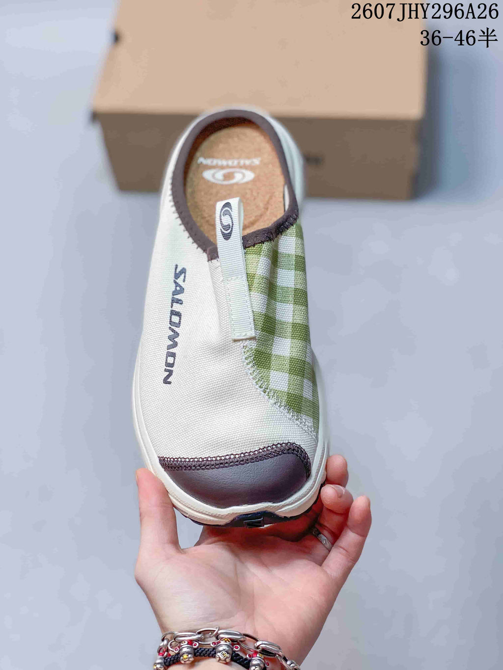 Top view of the Salomon slip-on showing the closed toe, pull tab, branded footbed and green check-pattern panel.
