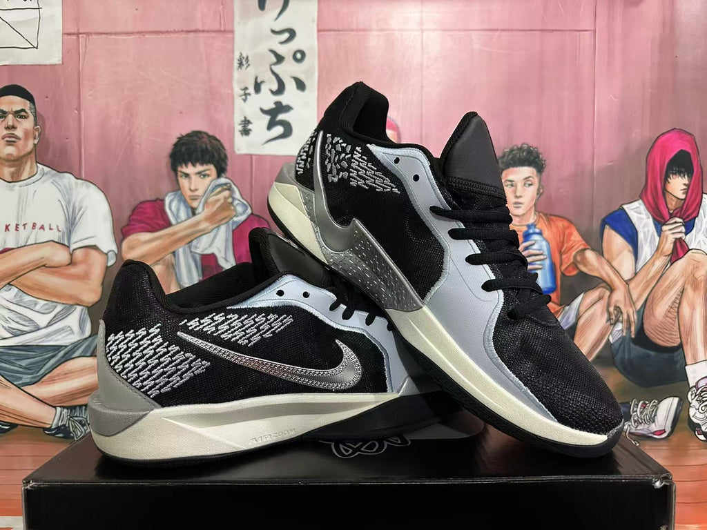 Pair of black and silver sneakers shown from angled side views
