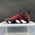 Side view of black Nike basketball sneakers with red wavy details, red laces, and white sole accents.