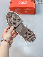 View of the textured rubber outsole with Converse All Star branding, alongside the orange shoebox showing the product code and 35–45 range.