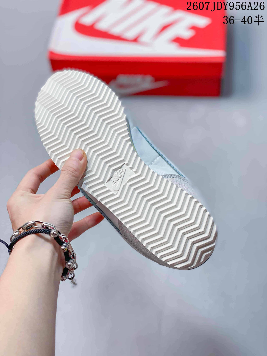 Bottom view showing the white herringbone-pattern outsole of the Nike sneaker.