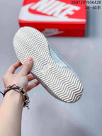 Bottom view showing the white herringbone-pattern outsole of the Nike sneaker.