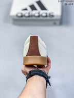 Rear view of the sneaker showing the brown heel detail and gum-colored heel outsole.