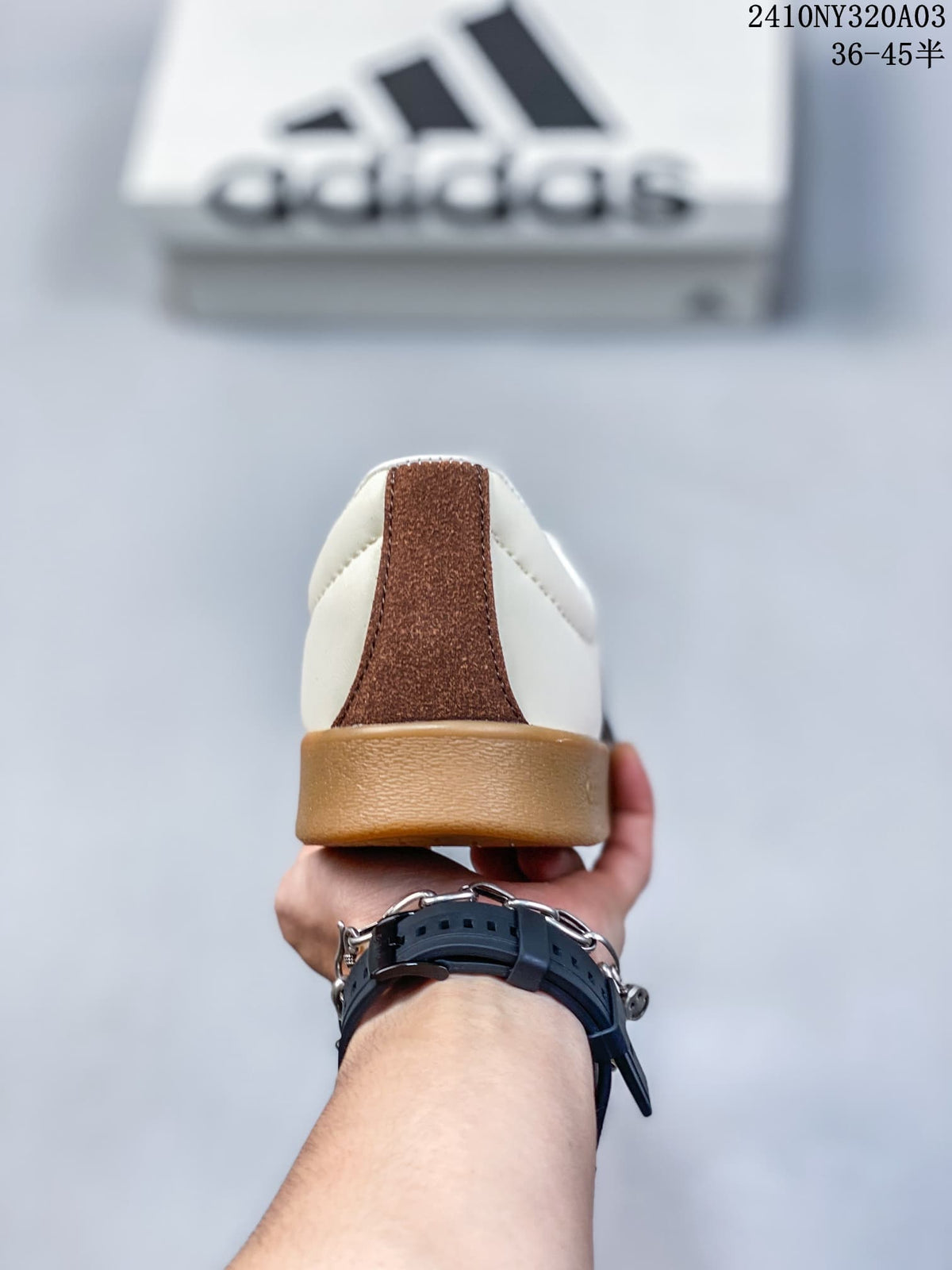 Rear view of the sneaker showing the brown heel detail and gum-colored heel outsole.