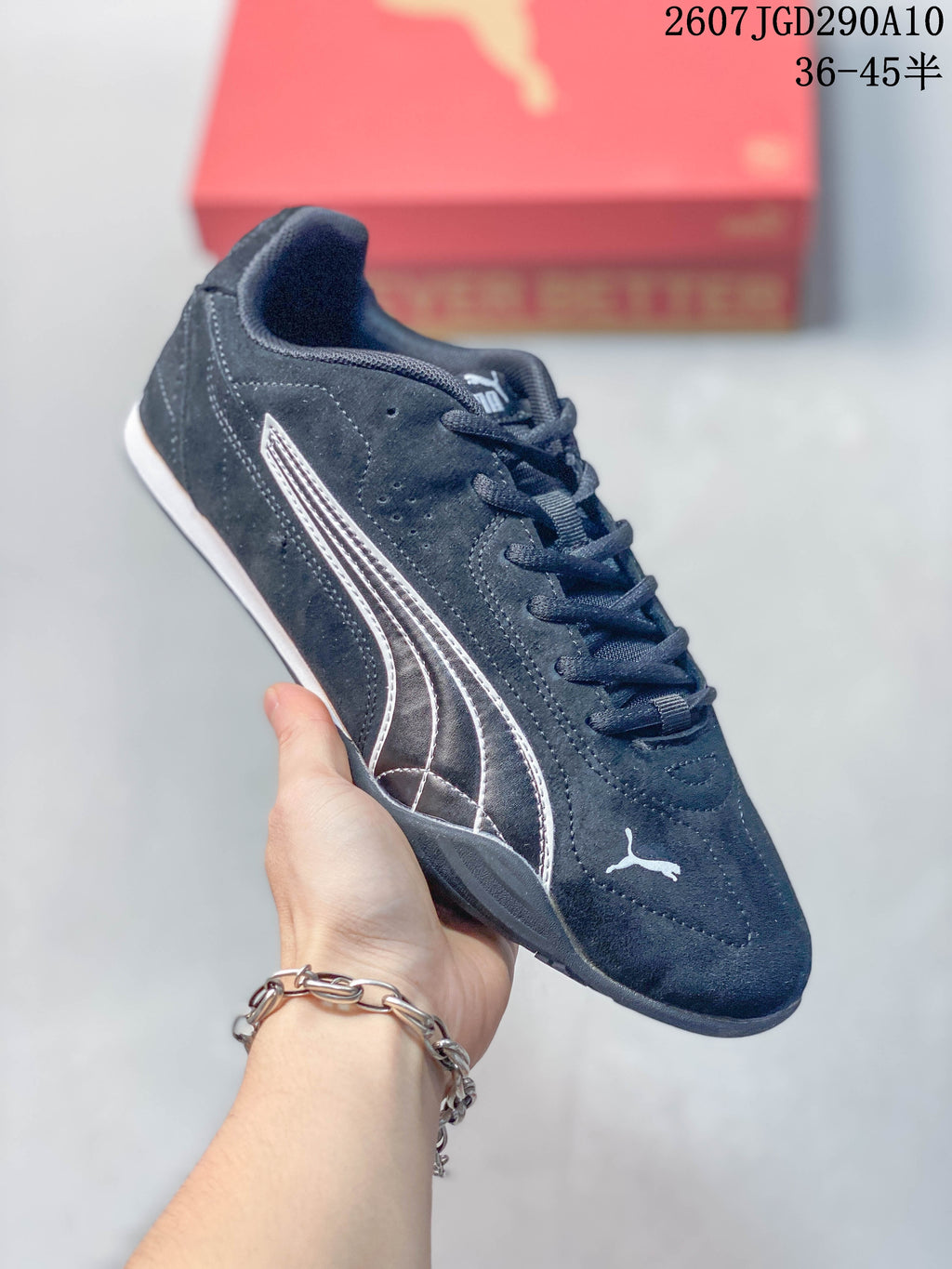 Angled side view highlighting the black upper, white Puma branding, lace-up front, and low sole.