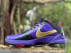 Side view of a purple and black Nike Kobe 5 shoe with a gold-colored logo and purple laces.