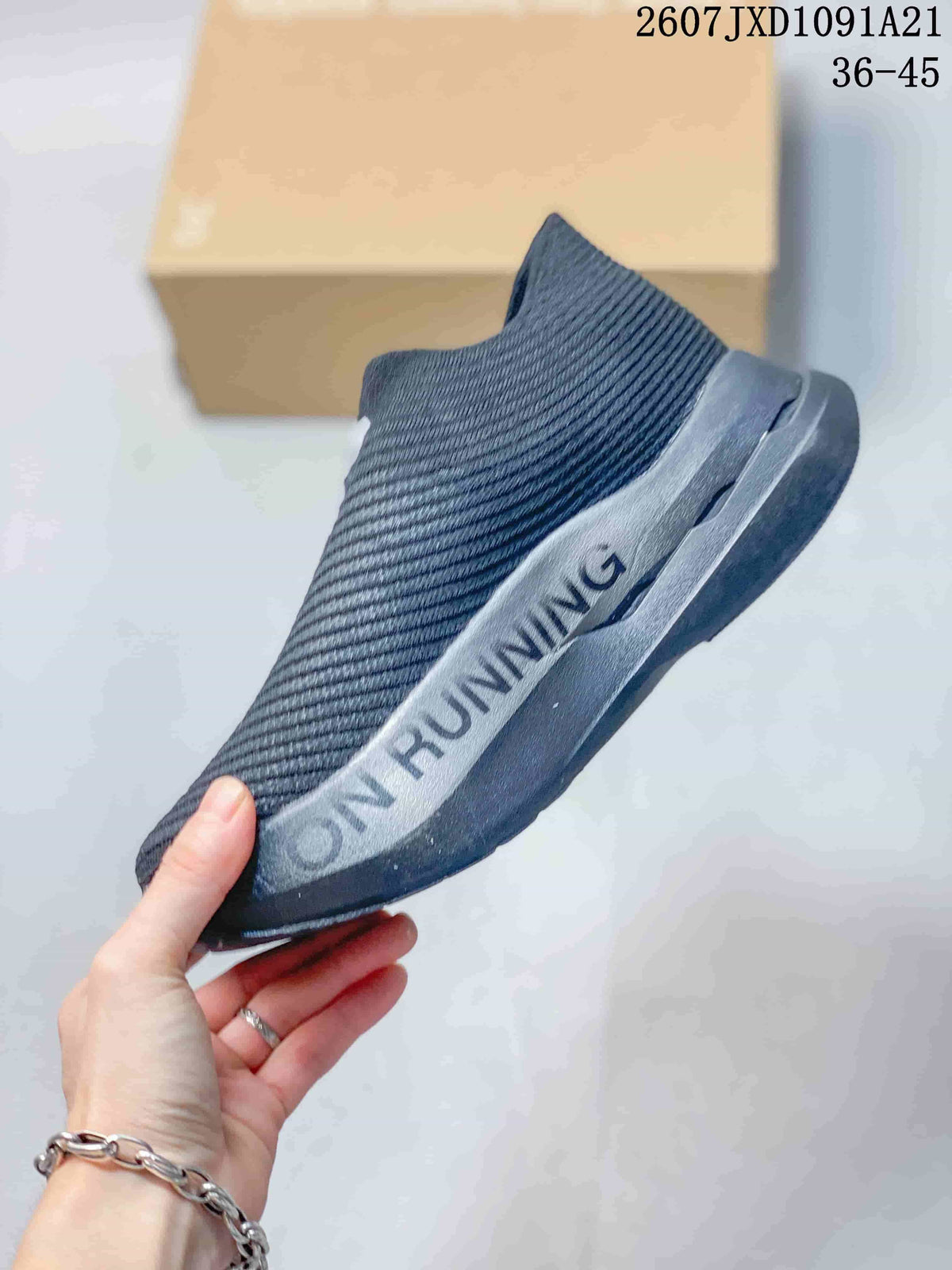 Side view highlighting the dark gray upper, white side detail, sculpted midsole, and outsole.
