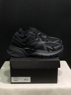 Side-front view of black AMIRI MA Runner sneakers with layered panels and chunky outsoles.