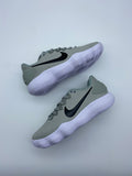 Pair of grey Nike low-top sneakers with black Swoosh logos and white ridged soles