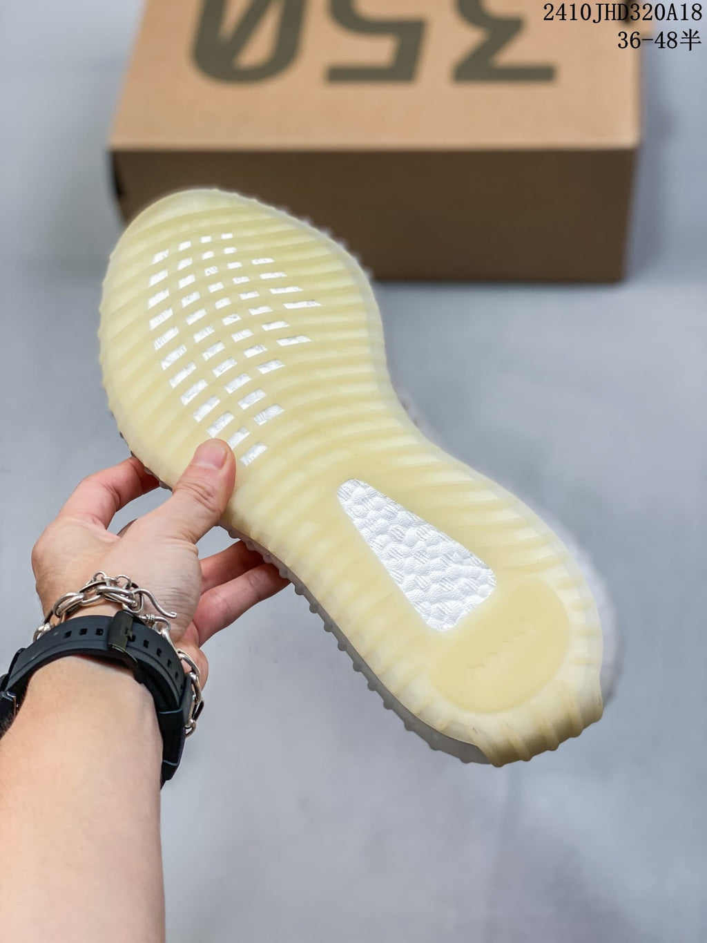 Close view of the translucent ribbed outsole on a Yeezy Boost 350 V2 sneaker.