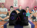 Rear view of black Jordan Tatum basketball shoes with purple heel details and a pink-purple upper.