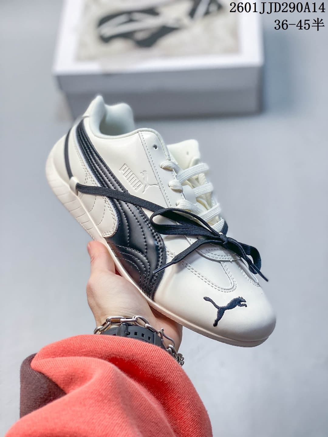 Side view of a white PUMA Speedcat TTF sneaker with a navy stripe and contrasting laces.